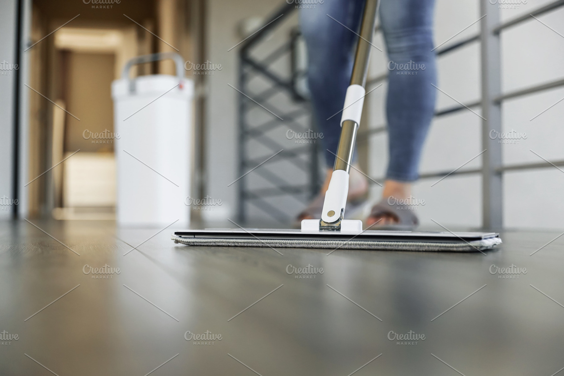 Woman mopping, wiping floor in modern home setting, a Person Photo by Lenor4ik