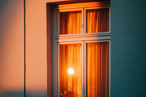 Glowing window at dusk with starry sky, an Architecture Photo by AlyaAnd