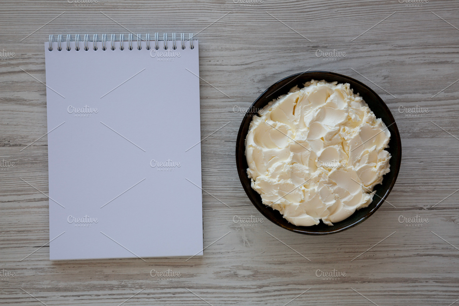 Organic White Mascarpone Cheese in a Bowl, top view., a Food & Drink Photo by LiudmylaChuhunova