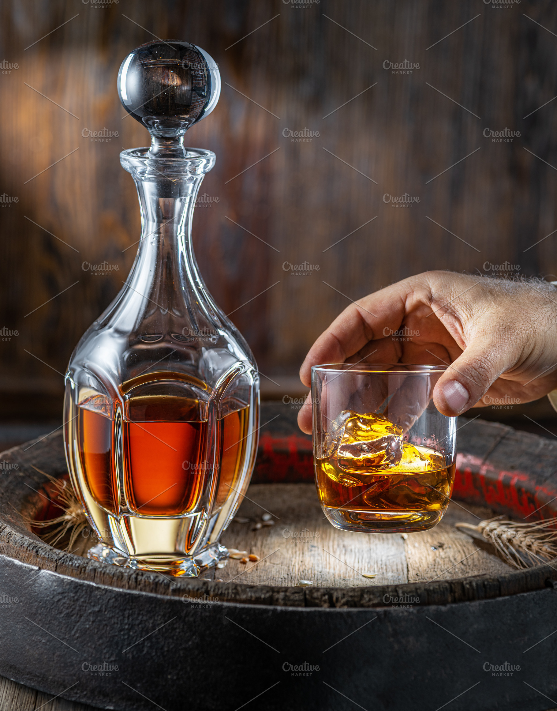 Carafe of whisky and glass of whisky on old wooden cask at the d, a Food & Drink Photo by Volff