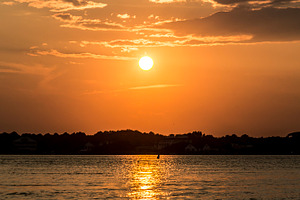 Ocean city containing sunrise, surfer, and surfers