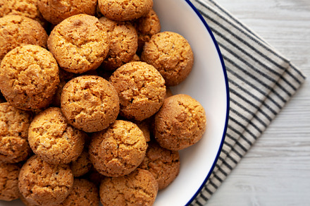 Homemade Sweet and Crunchy Amaretti on a Plate, top view. Flat l, a Food & Drink Photo by LiudmylaChuhunova