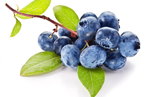 Blueberries with leaves on a white background.