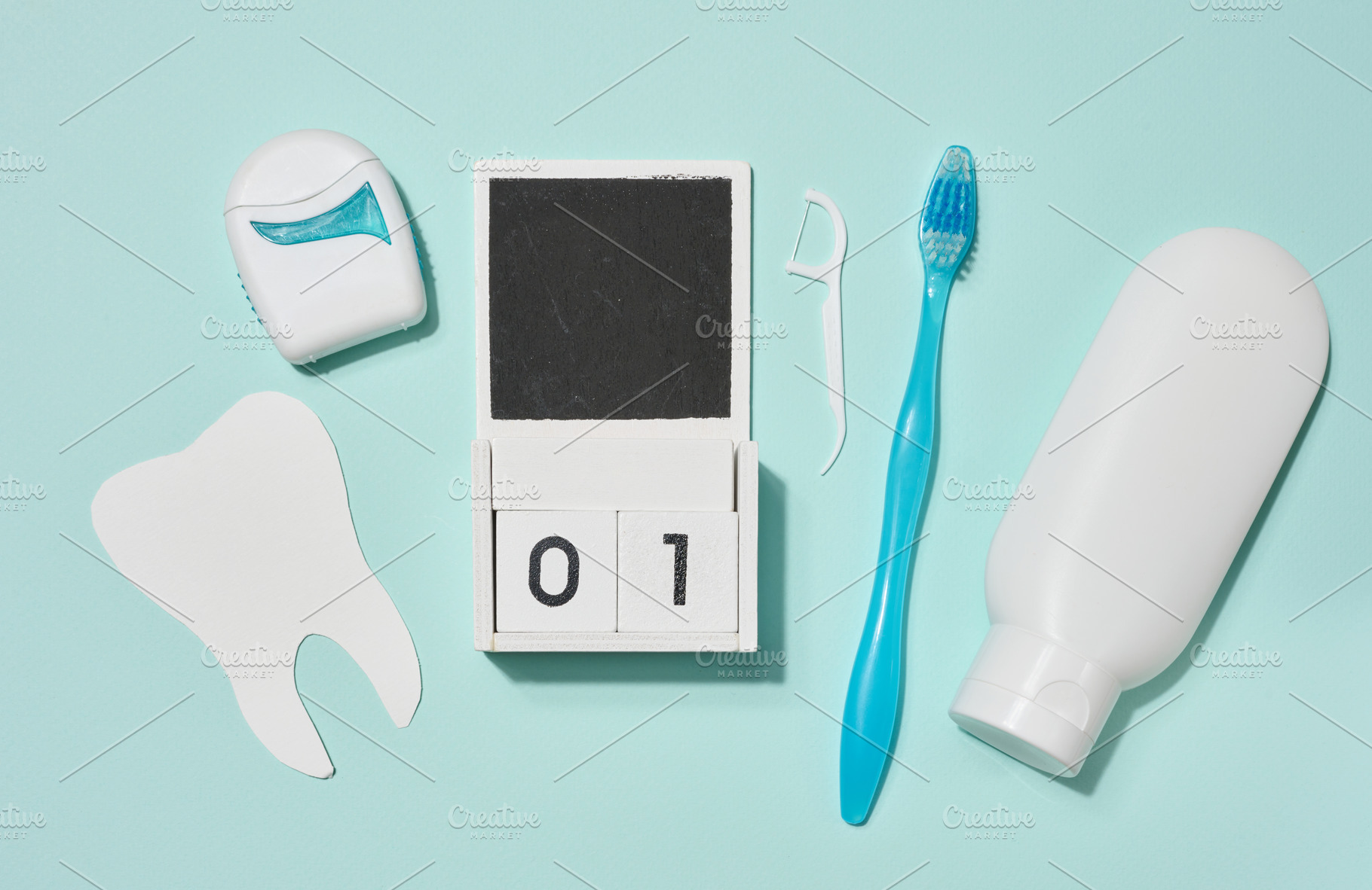 Blue toothbrush, white tube of toothpaste, dental floss in blue, a Health & Medical Photo by ndanko