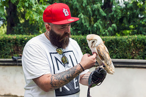 Hipster with an owl in his hand, a Person Photo by BOOCYS
