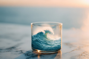 Wave in a glass on a beach background, an Abstract Photo by AlyaAnd