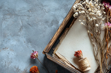 Wooden box filled with dried flowers on gray textured surface., an Abstract Photo by Natalia Klenova's Shop