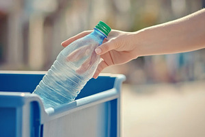Hand putting Recycling plastic bottle in blue bin, eco-friendly, a Photo by Dvoevnore photos