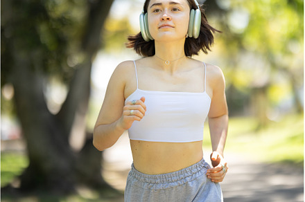 A woman is running in a park with