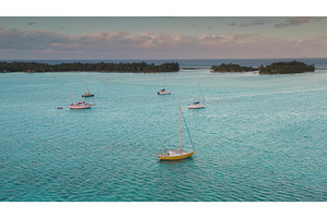 Sailboats anchored near tropical, a Nature Photo by Goinyk
