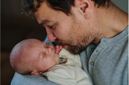 Close-up of father cudddling his, a Person Photo by HalfPoint