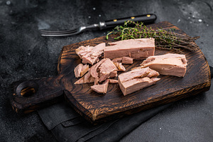 Chunky tinned tuna served on a wooden board, perfect for meal pr, a Food & Drink Photo by composter-box@mail.ru