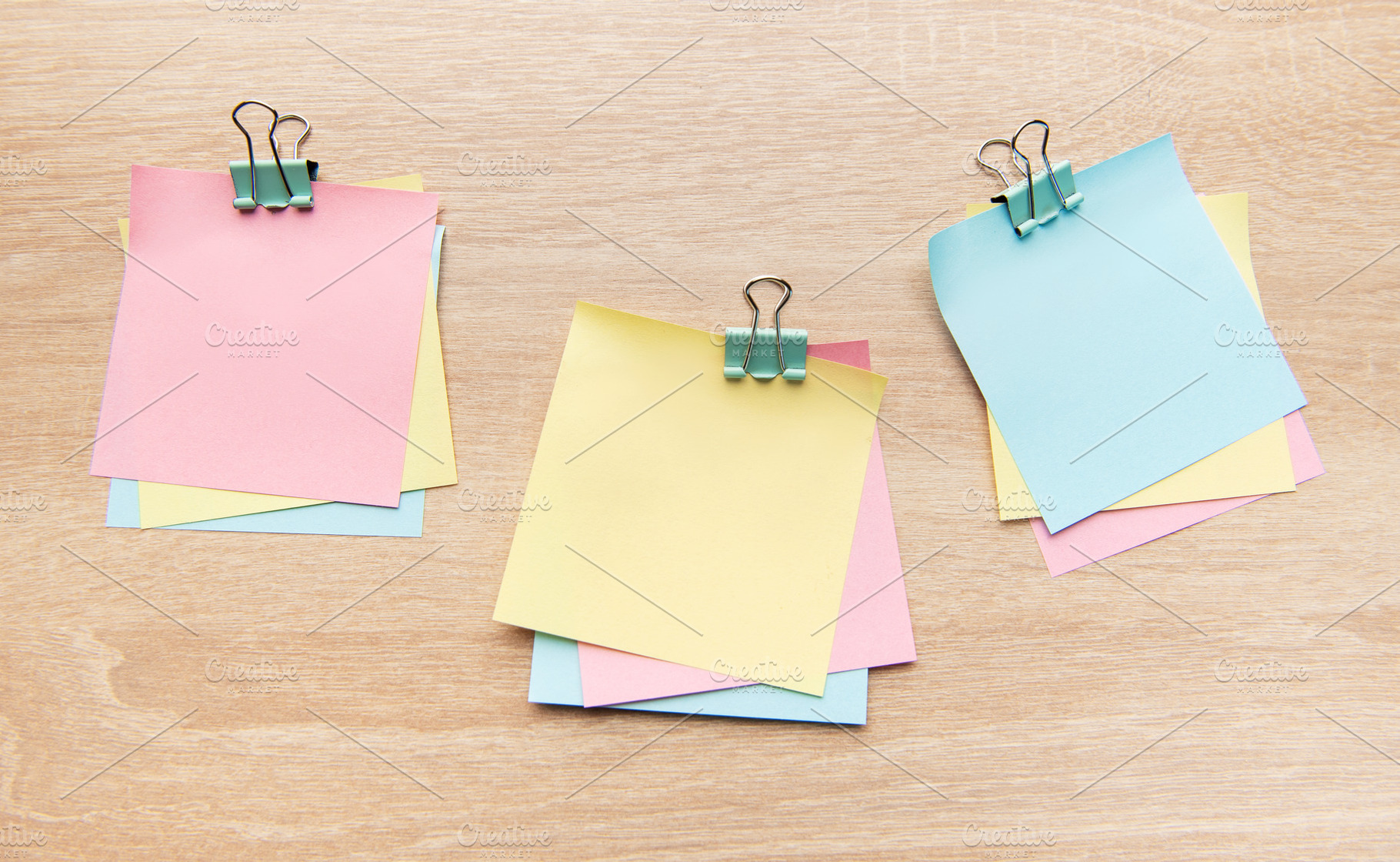 Colorful sticky notes and binder clips on wooden desk, a School & Education Photo by Olena Rudo