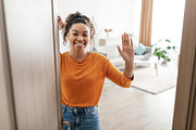 Cheerful Black Female Opening Door Of House Waving Hand Indoor, a Photo by Prostock-Studio (Thumbnail 2 of 2)