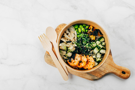 Poke bowl with shrimp, avocado, rice, mango and vegetables with sesame seeds, w, a Food & Drink Photo by Anikona