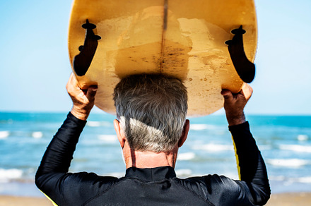A senior man with a surfboard featuring active, activity, and adventure, a Holiday Photo by rawpixel