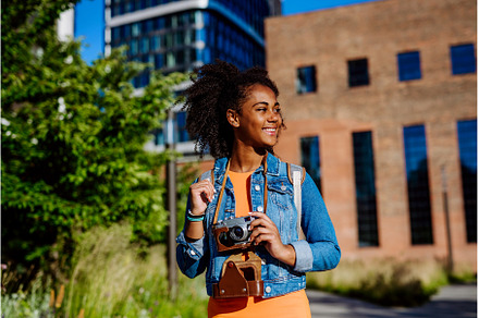 Multiracial girl walking in city, a Person Photo by HalfPoint