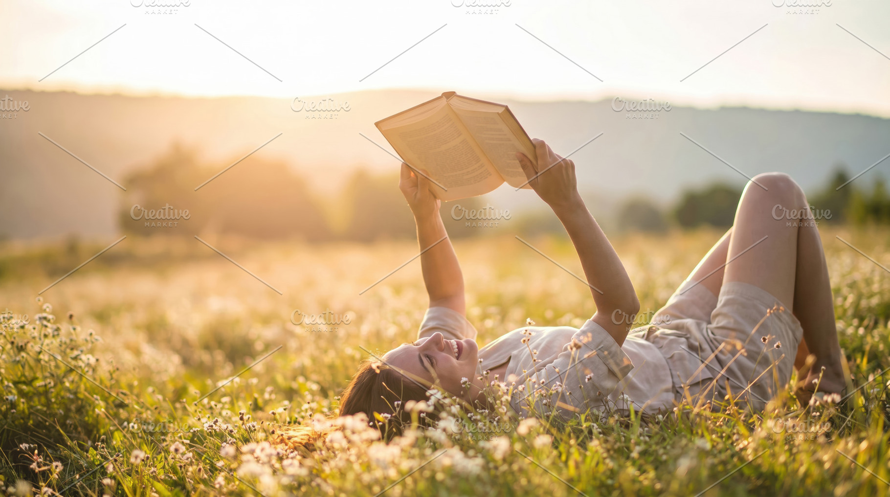 Woman Reading Book in Sunny Wildflower Meadow, a Photo by Davizro's Market