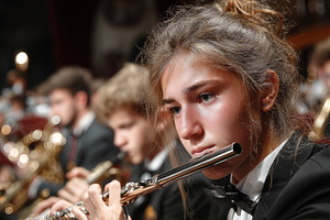 Focused flutist performs during a captivating orchestra concert in formal attir, a Photo by AS photostudio
