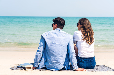 Vacation romantic lovers young happy couple hug and sit on sand, a Person Photo by Art_Photo
