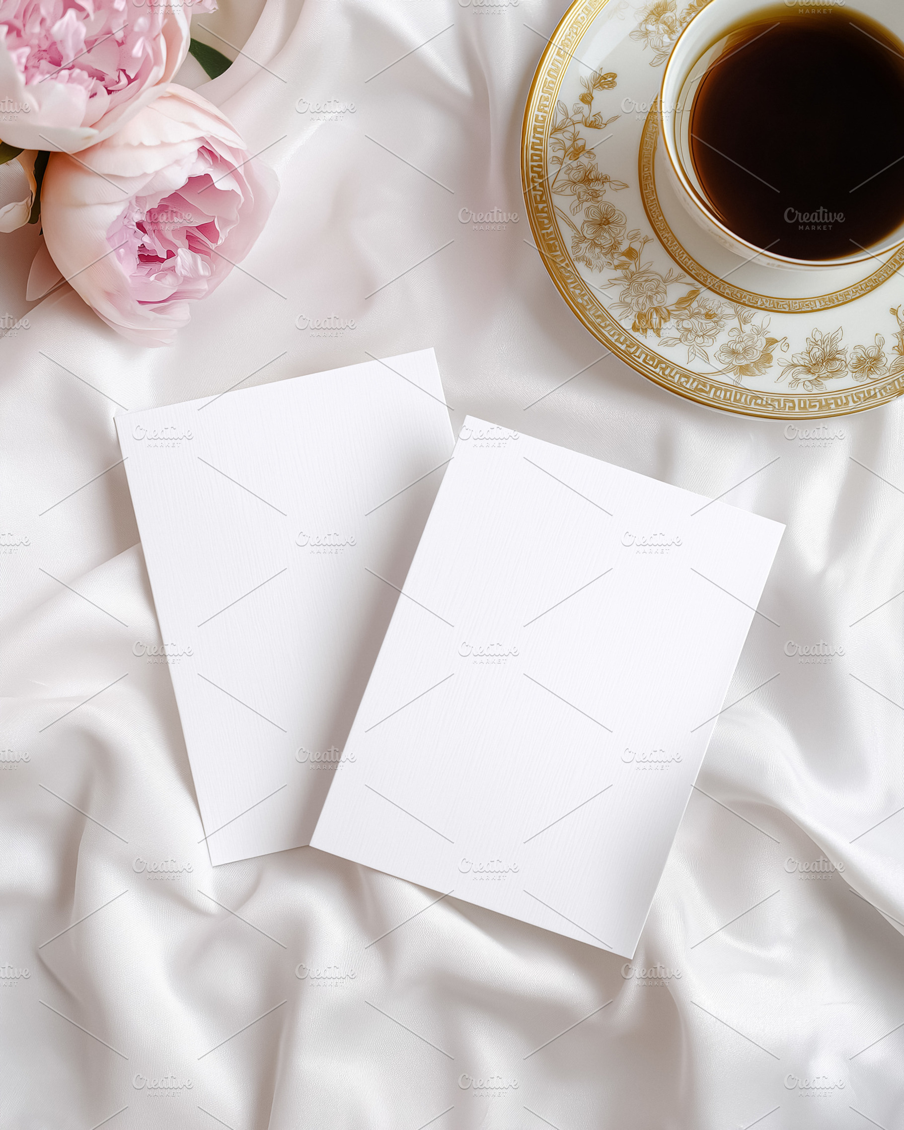 Two blank vertical cards arranged on white silk fabric with pink peonies and an, a Holiday Photo by Studio ANNA