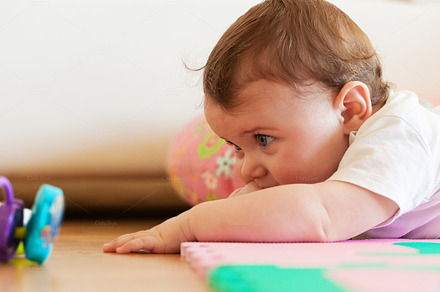 Toddler plays on the floor.