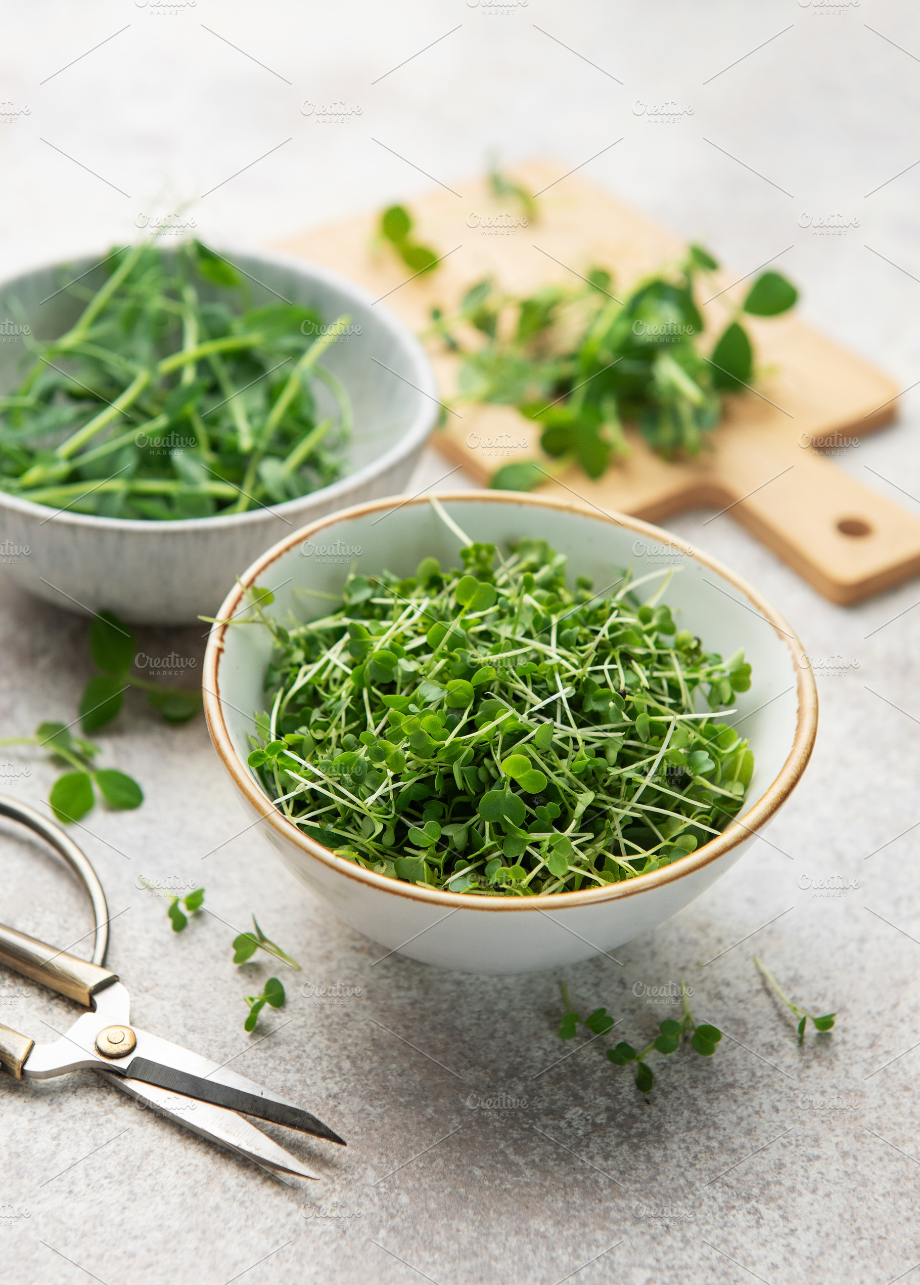 Fresh green microgreens in bowls for healthy eating, a Photo by Olena Rudo