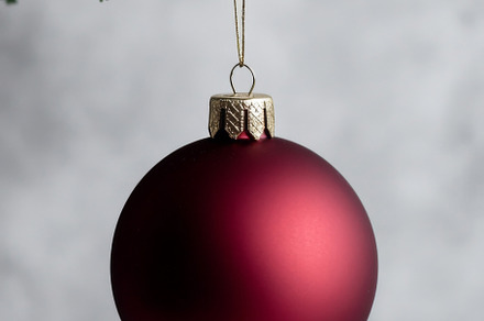 Red Christmas ornament hanging from Christmas tree branch, suita, a Photo by Dvoevnore photos