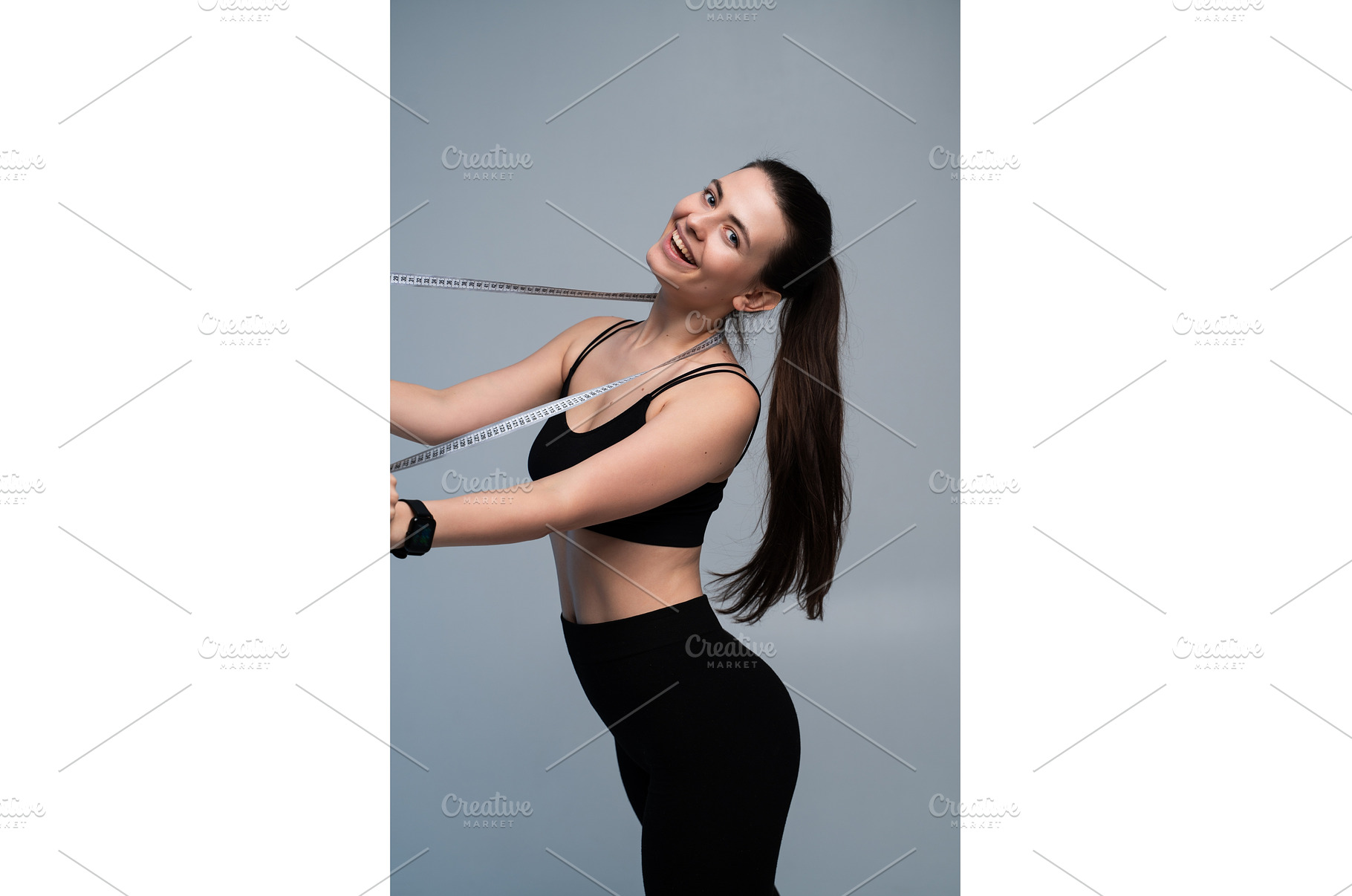 Happy young woman smiling, measuring, a Sports & Recreation Photo by volodymyrshtun13795