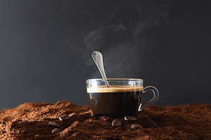 Cup of hot coffee over ground coffee and dark background, a Food & Drink Photo by Davizro's Market