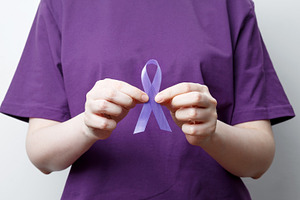 Purple ribbon held by a person in a purple shirt, symbol of support. Purple Epi, a Photo by matucha