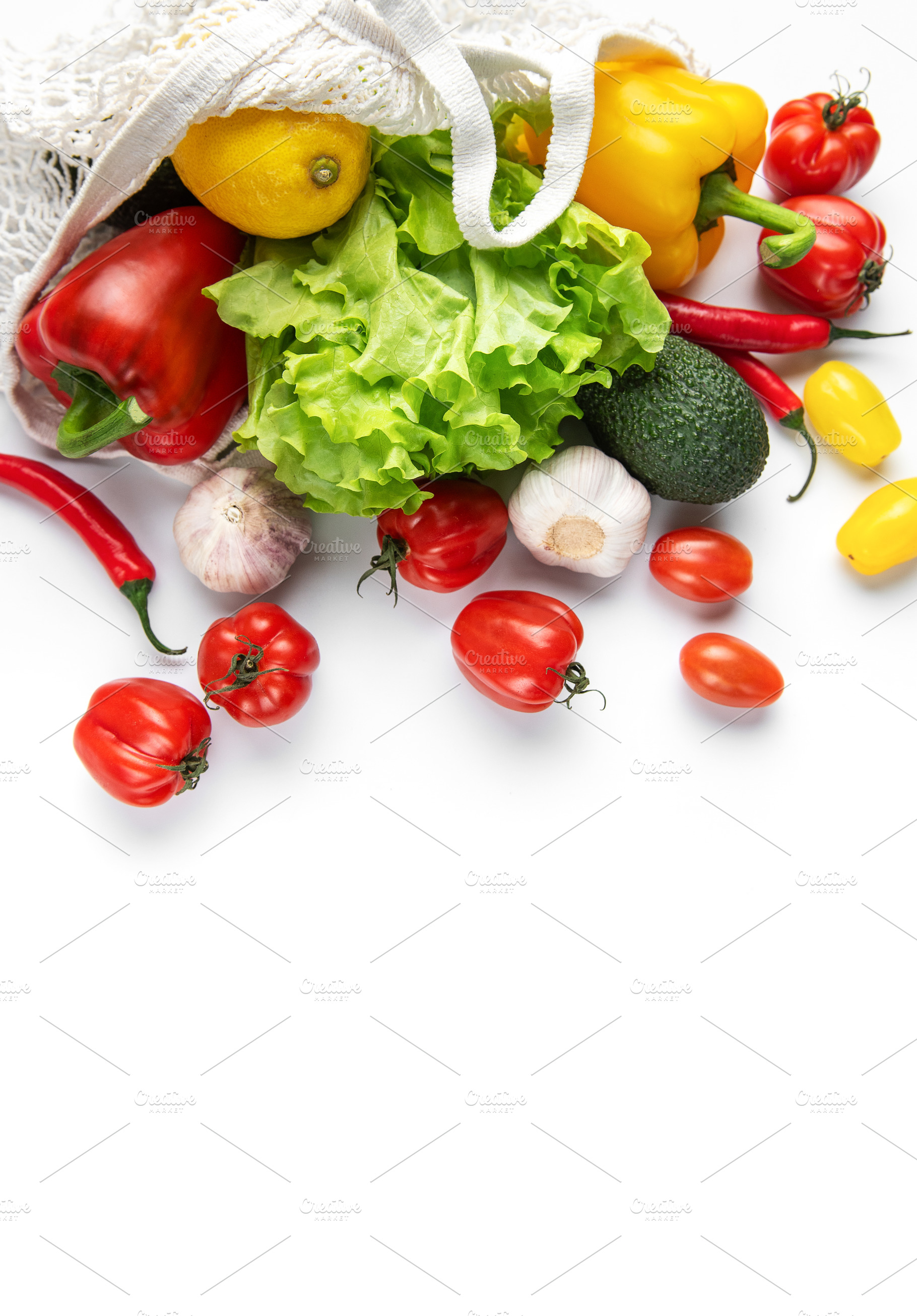 Fresh organic produce spilling from reusable mesh bag, a Food & Drink Photo by Olena Rudo