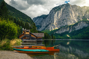 Moored boats on the lake shore, a Nature Photo by Alpine Dreams