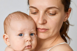 Woman with baby portrait showing gentle closeness, a Person Photo by GoodGoods