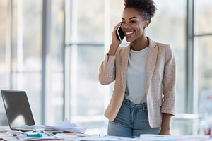 Smiling woman on phone at work, a Photo by Beautiful things