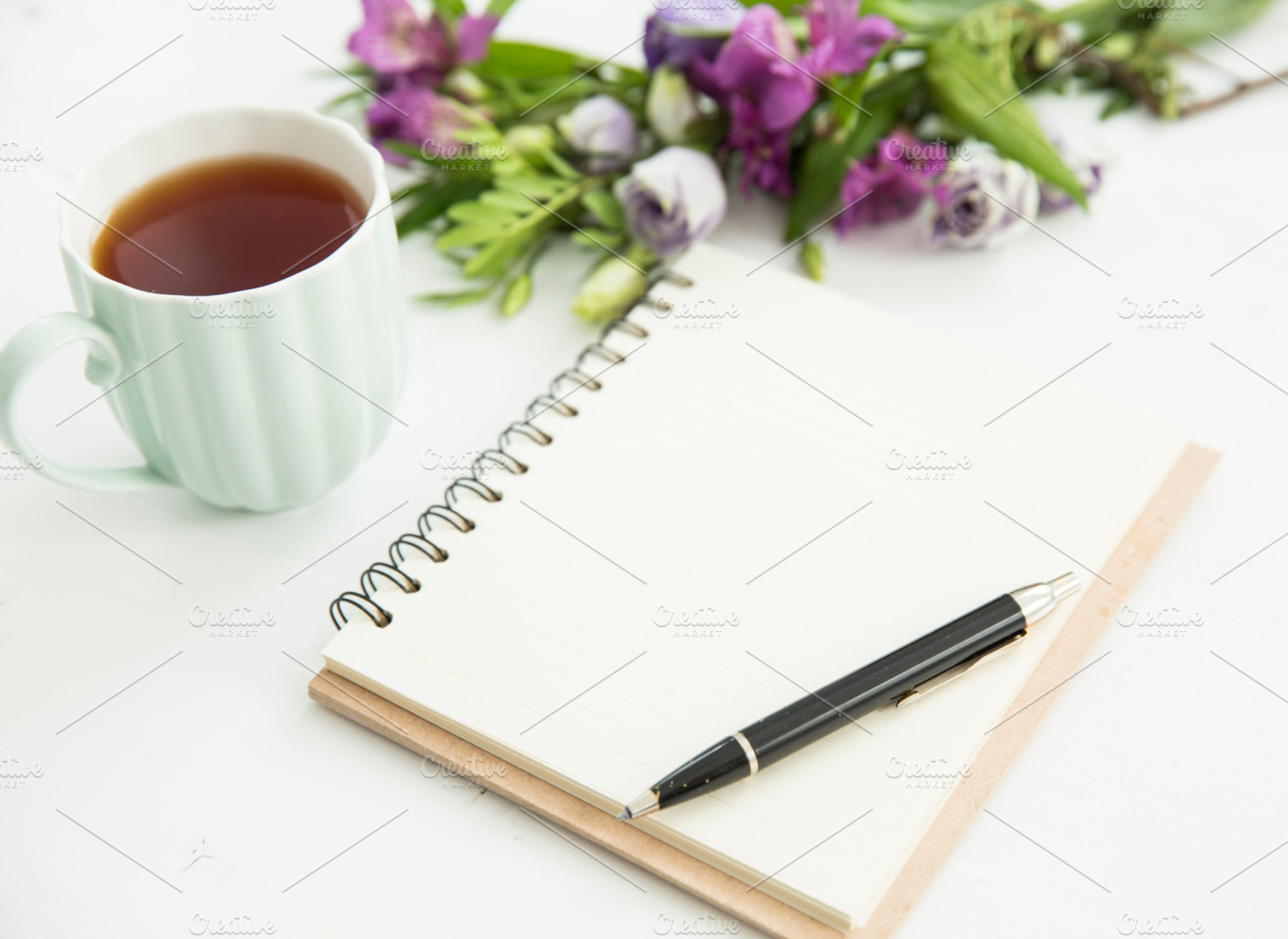 Desk with tea notebook and flowers stock photo containing notebook and tea, a Beauty & Fashion Photo by Izdebska