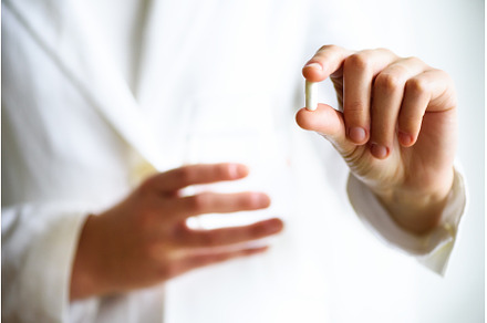 Doctor holding a glass of water with