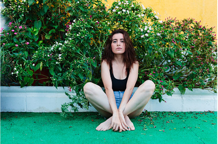 Thoughtful woman sitting alone, a Person Photo by Manu Reyes