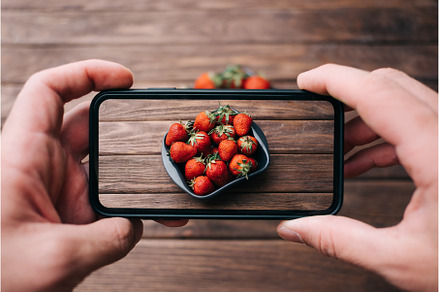 Man taking photo berries., a Food & Drink Photo by P&G