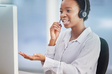 Black woman, customer support staff and call center employee working at desk of an online telemarketing business. Crm consultant, talking online and consulting client for a computer or software issue, a Photo by Peopleimages.com