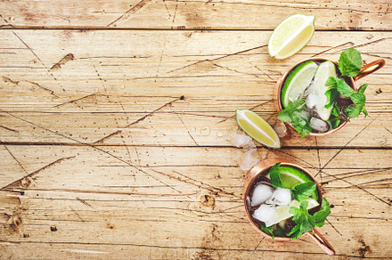 Moscow mule cocktails in copper mug with lime, ice, ginger beer,, a Food & Drink Photo by 5PH