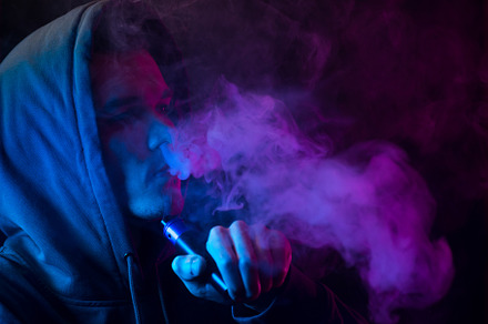 A man exhales a cloud of smoke or steam, neon style photos, a Person Photo by PavelKant