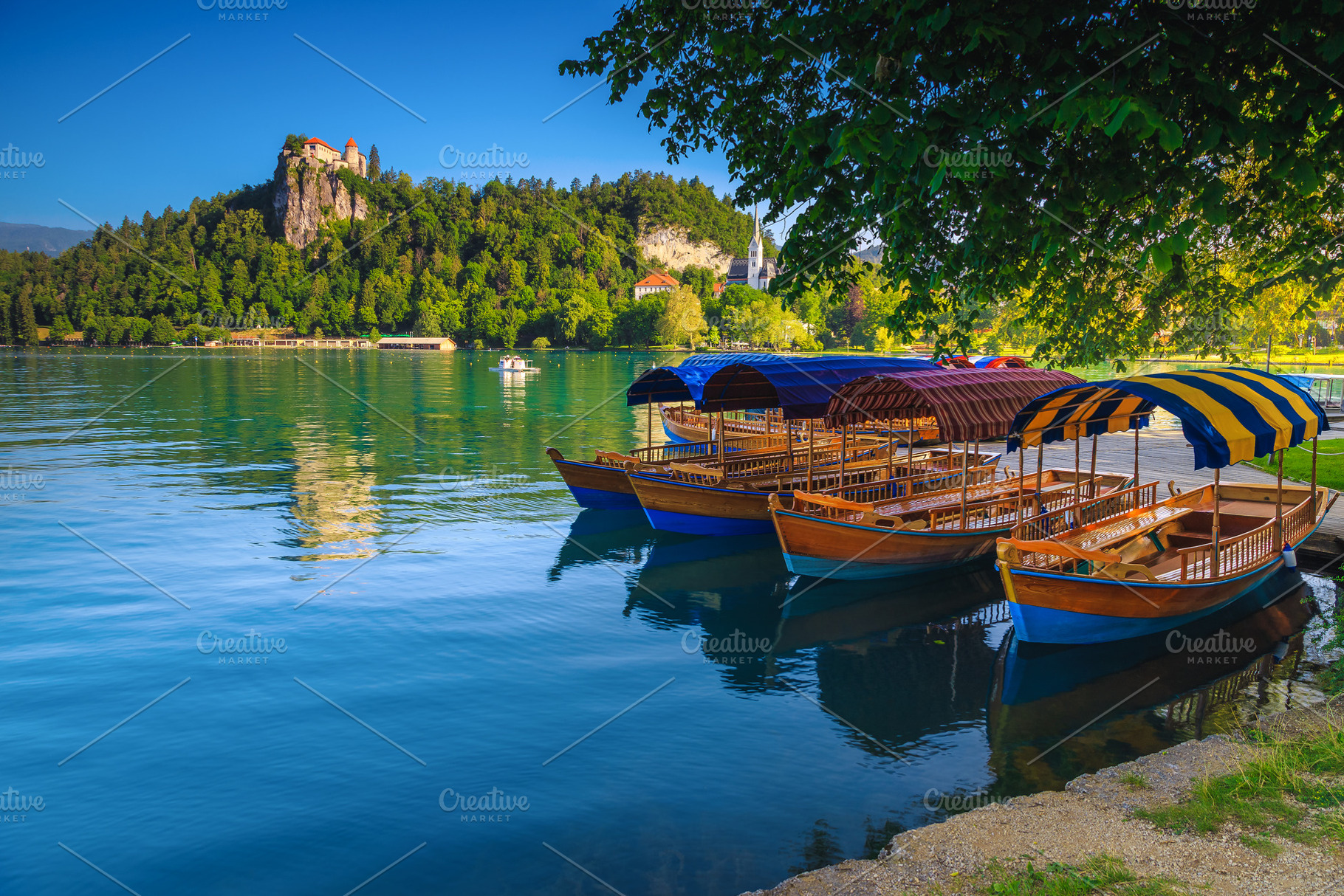 Wooden boats anchored on the lake, a Transportation Photo by Alpine Dreams