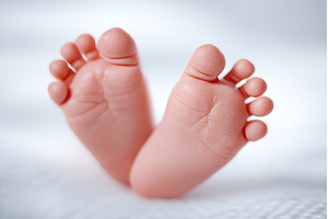 Newborn baby's tiny feet come into, a Person Photo by ZinetroN