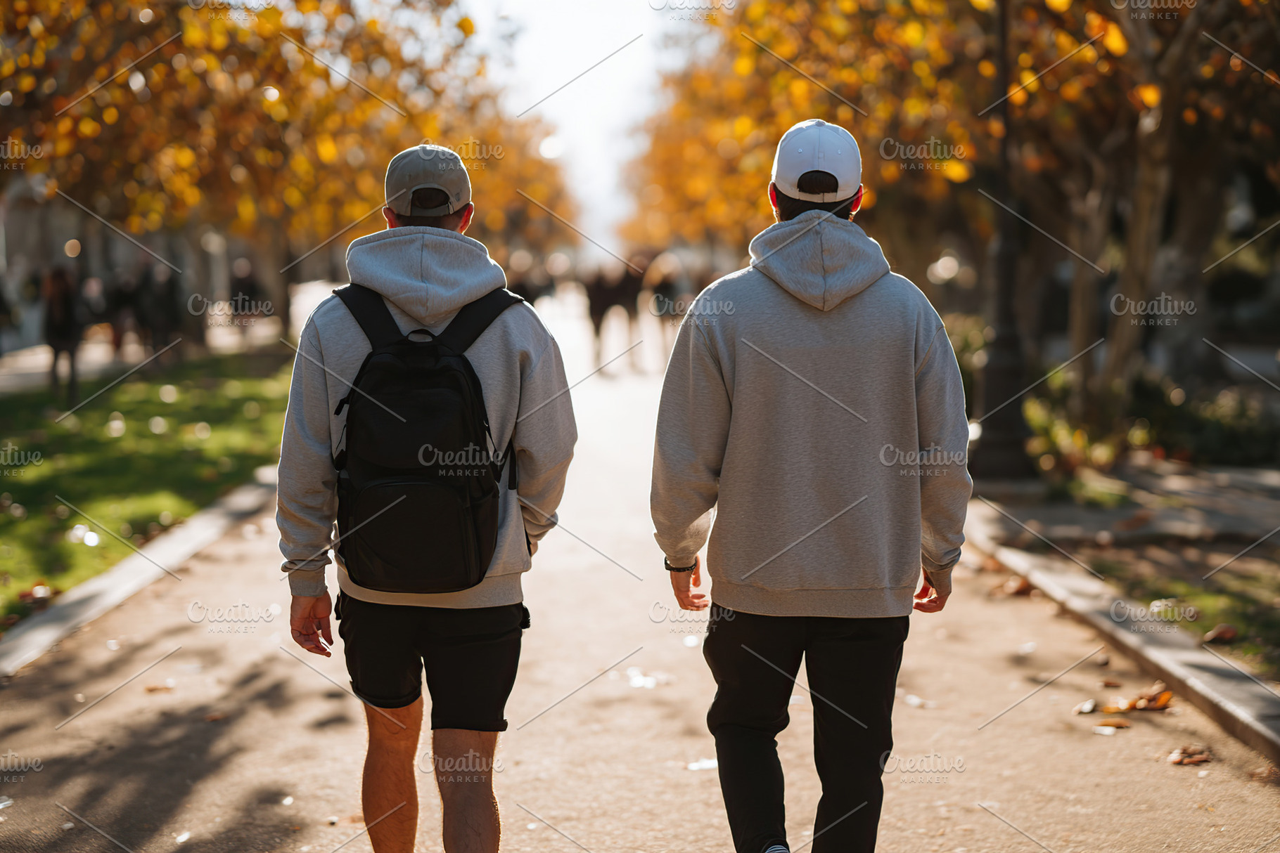 Friends walking together on a sunny day in a tree-lined park during autumn, a Person Photo by AlyaAnd