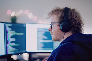 Young Caucasian Male Coder Working, a Technology Photo by Lermont51