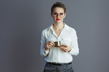 modern female employee in white blouse isolated on grey, a Business Photo by Alliance Images