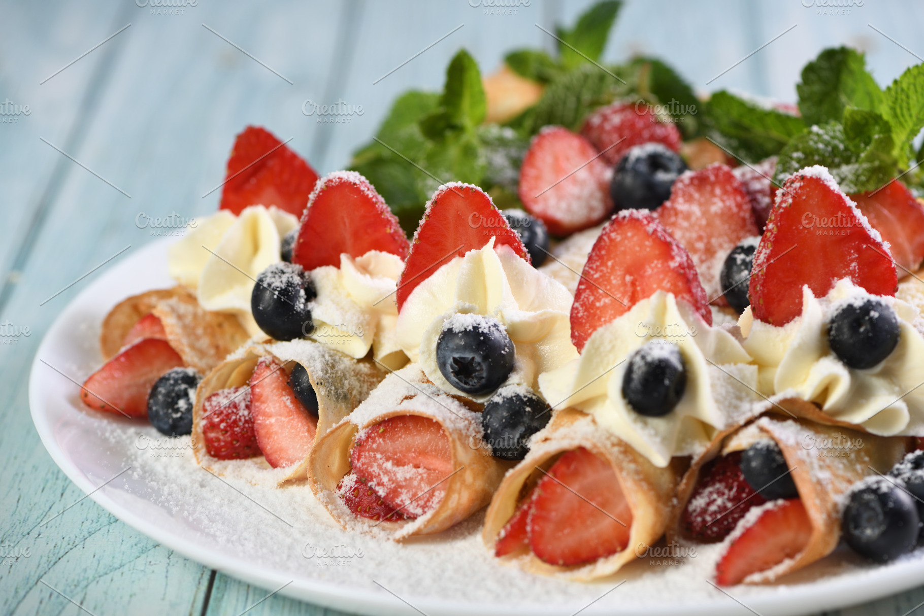French crepes with cream and berries, a Food & Drink Photo by Apolonia