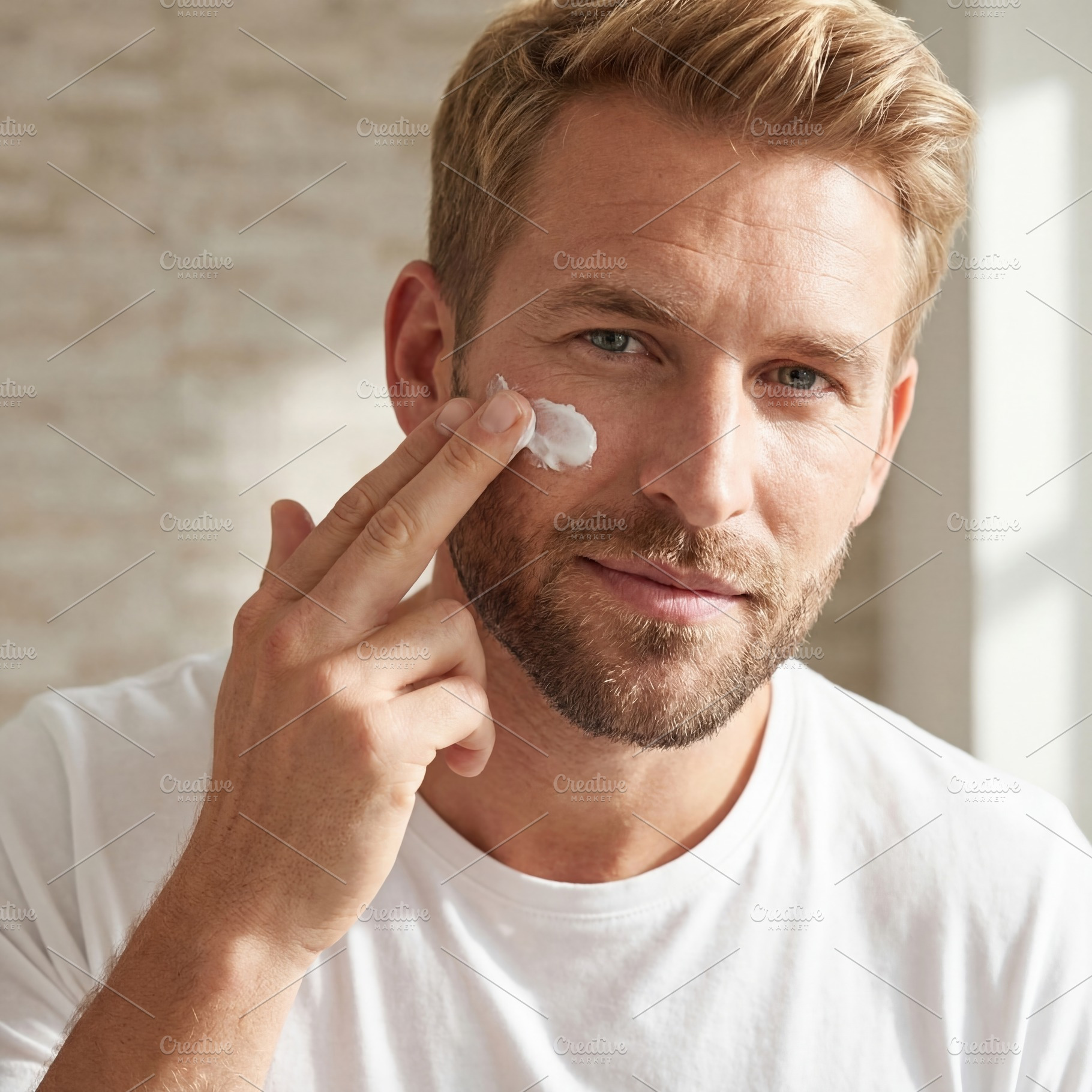 Man Applying Skincare Cream to Face, a Beauty & Fashion Photo by Virgo Studio