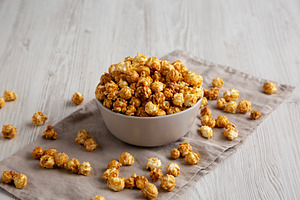 Homemade Caramel Popcorn in a Bowl, side view., a Food & Drink Photo by LiudmylaChuhunova